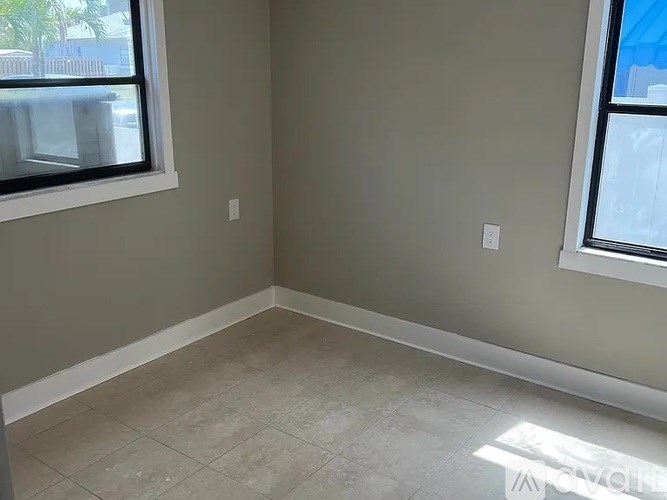A room with a tiled floor and a window.