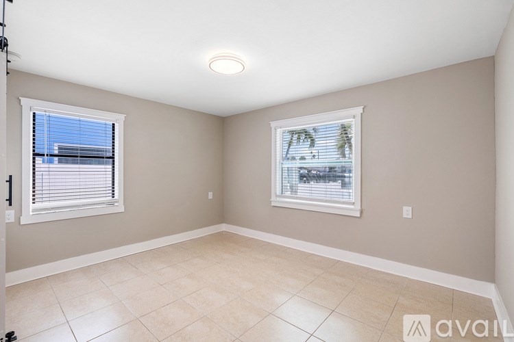 A room with a window and a tiled floor.