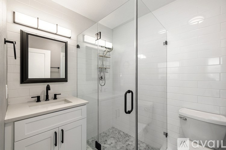 A bathroom with a white sink and a mirror above it.