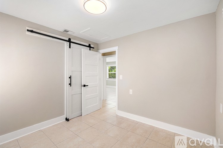 A room with a sliding door and tiled floor.