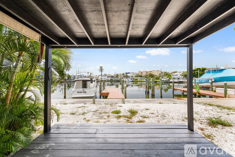A wooden walkway leads to a beachfront property.