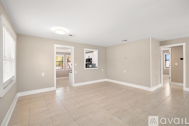 A white bathroom with a glass shower door and a toilet.