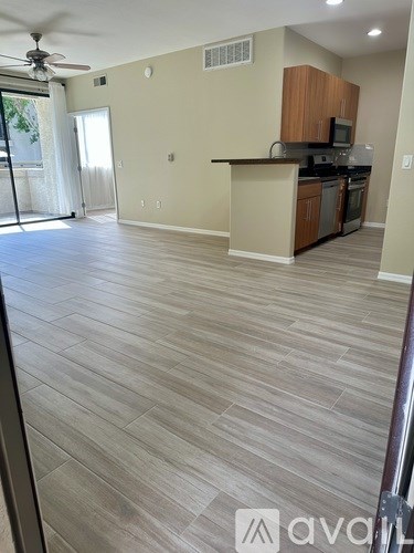 A kitchen with wooden cabinets and a countertop is visible.