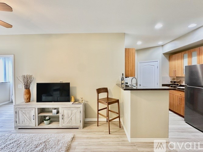 A room with a ceiling fan and a white door.
