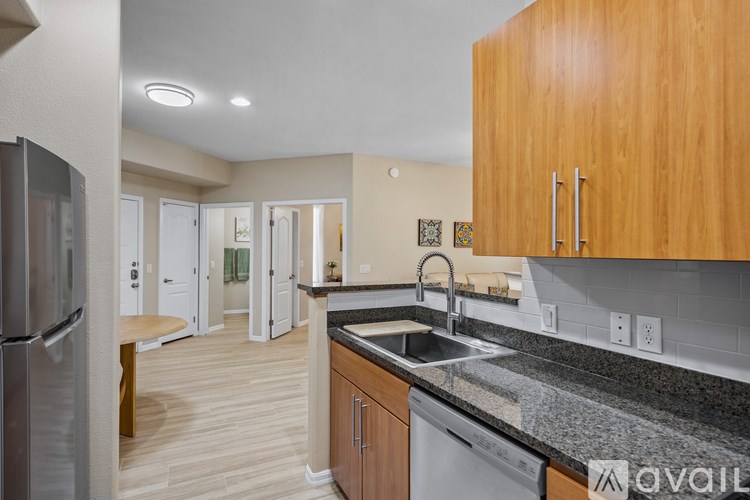 A kitchen with a bar area and a dining table.