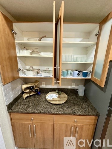 A kitchen with wooden cabinets and granite countertops.