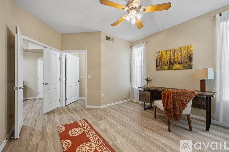 A kitchen with a white oven and microwave, a white refrigerator, and a white door.