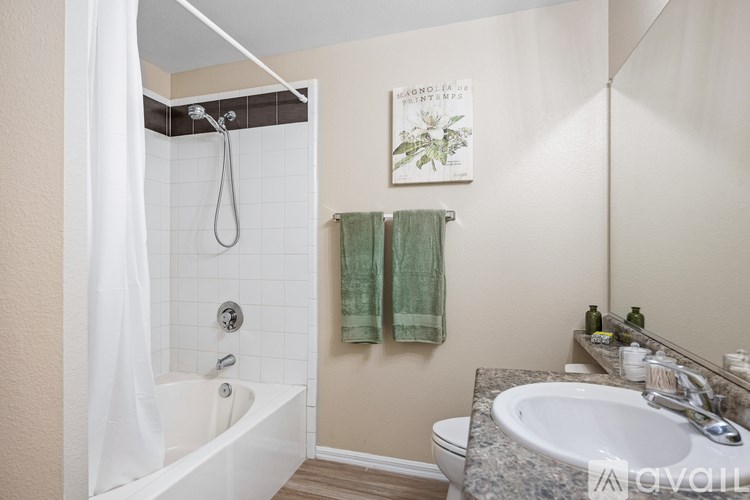 A bedroom with a bed, a ceiling fan, and a sliding glass door.