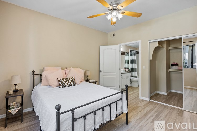 A white bathtub with a shower head and a towel on the side.