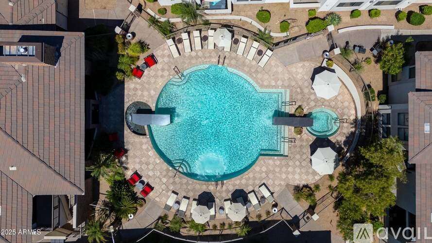 A kitchen with wooden cabinets and a stainless steel refrigerator.