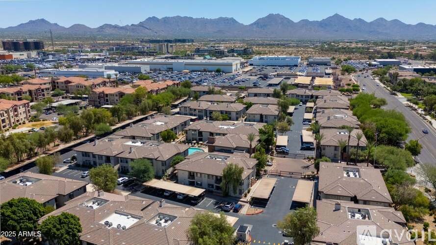 A bird's eye view of a residential area with houses and a parking lot.