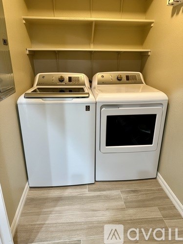 A white dishwasher and oven in a kitchen.