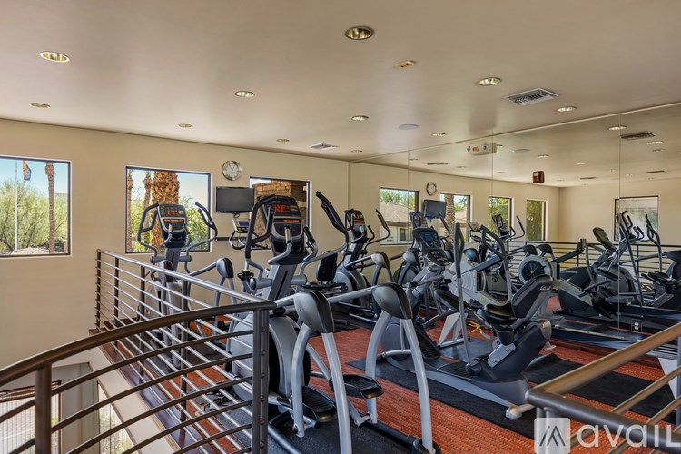 A gym with treadmills and elliptical machines.