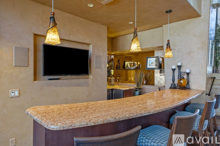 A bar area with a counter and chairs.