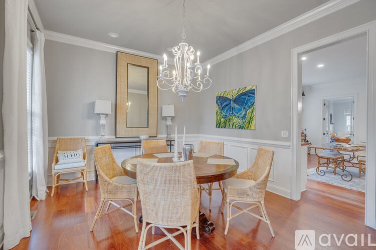 A dining room with a round table and chairs.
