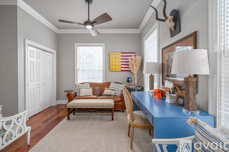 A room with a blue desk and a brown chair.