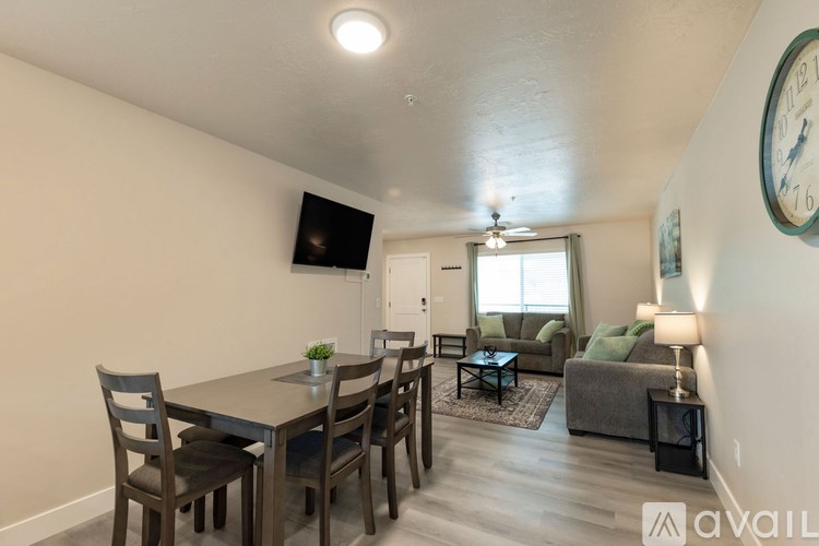 A dining room with a table and chairs is available for rent.