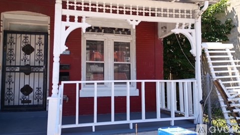 A red house with a white door and windows.