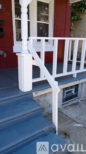 A red house with a white porch.