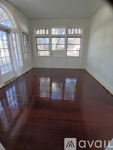A room with a wooden floor and white walls.