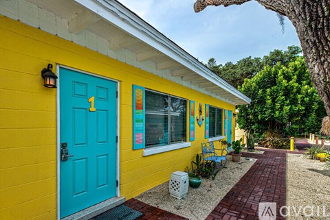 A yellow house with a blue door and window.