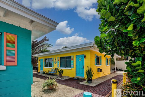 A yellow house with a blue door and a red window.