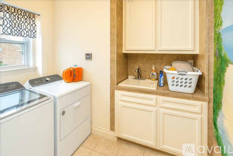 A small laundry room with a washer and dryer.