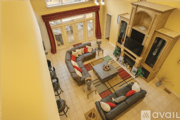 A living room with a couch, chairs, and a coffee table.