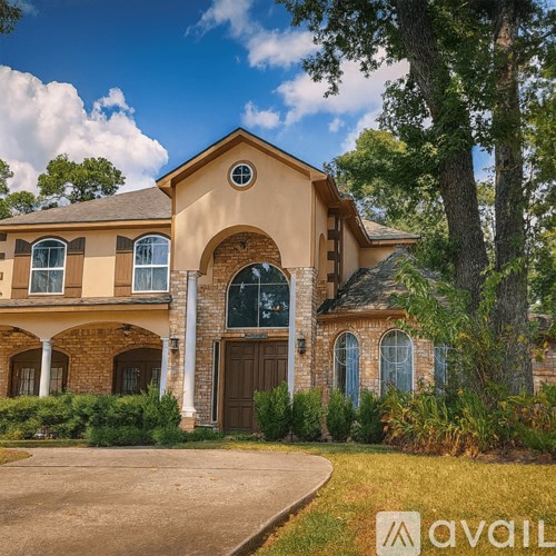 A large house with a brown door and windows surrounded by greenery.