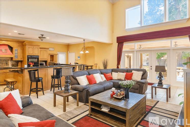 A living room with a grey couch and a wooden coffee table.