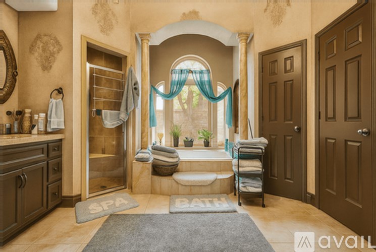 A bathroom with a large window and a towel rack.