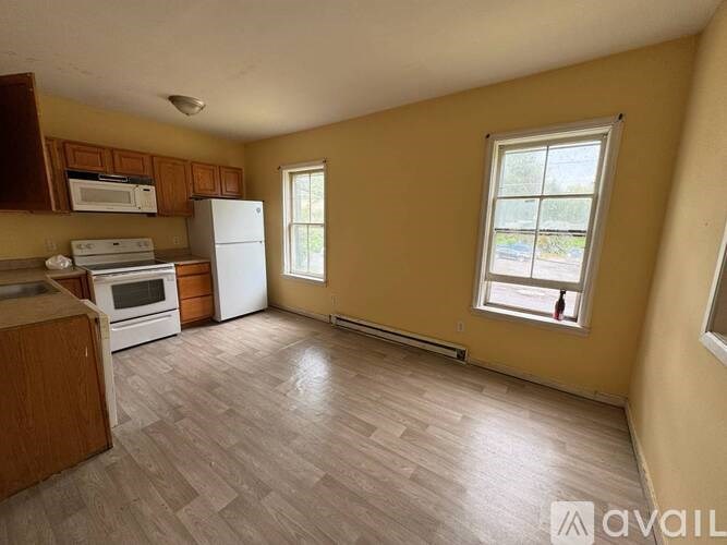 A kitchen with wooden cabinets and a white refrigerator.