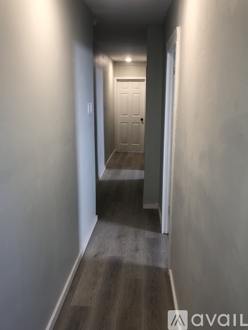 A long hallway with a door at the end.