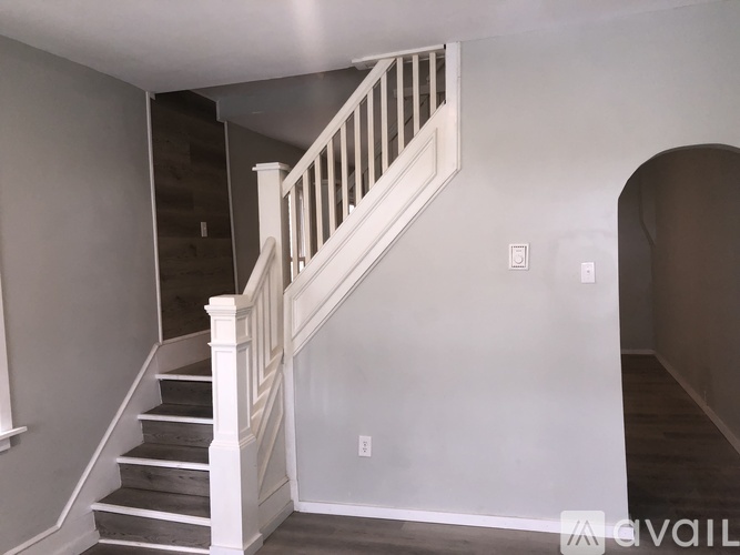 A staircase with a white railing and wooden steps.