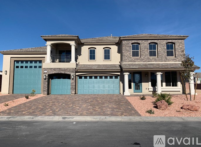A two-story house with a blue garage door is for sale.