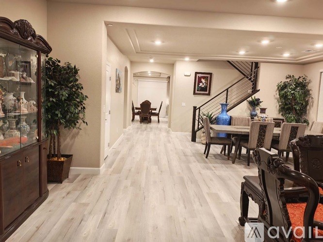 A long hallway with a table and chairs on the right side.