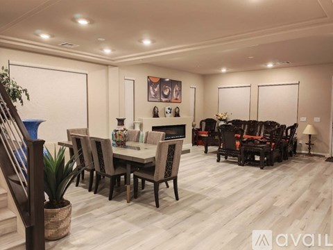 A living room with a dining table and chairs.