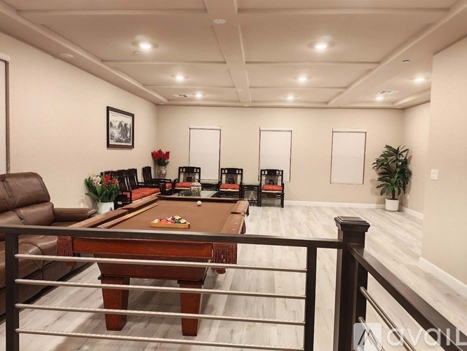 A living room with a pool table and a couch.