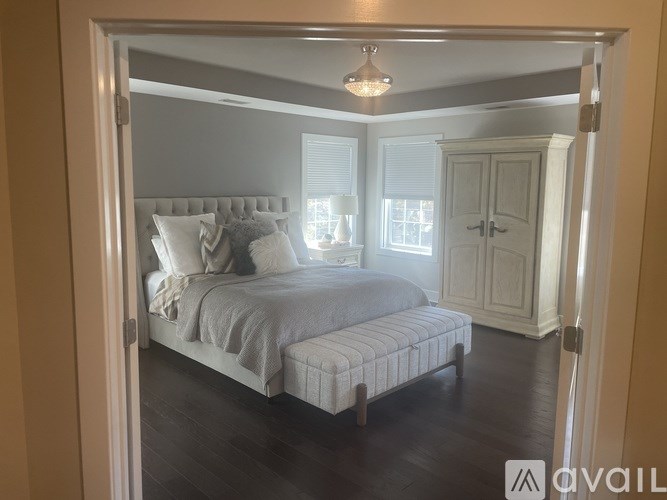 A grassy field with a house in the background and a watermark that says "available".