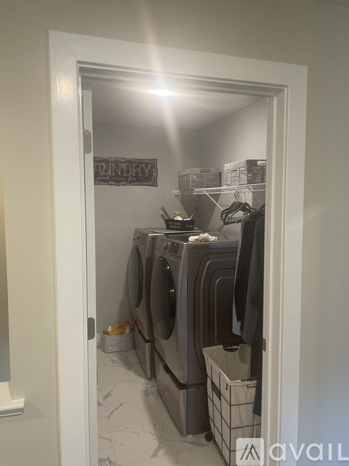 A laundry room with a sign that says "Laundry" on the wall.