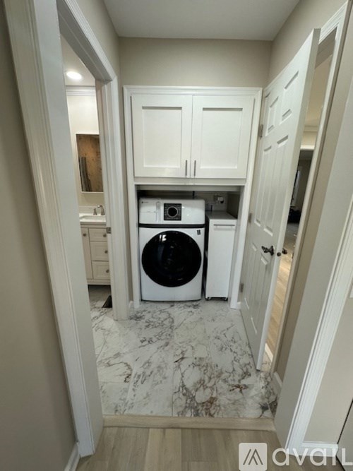 A small laundry room with a washer and dryer.