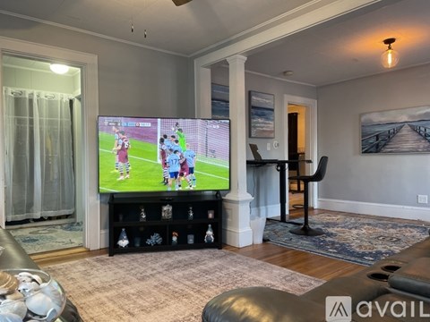 A living room with a television playing a soccer game.
