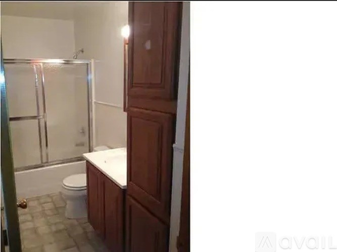 A bathroom with a toilet, a tub, and a shower.