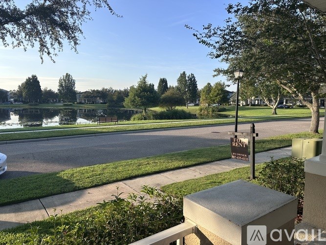 A view of a park with a lake and a sign that says "RENT".