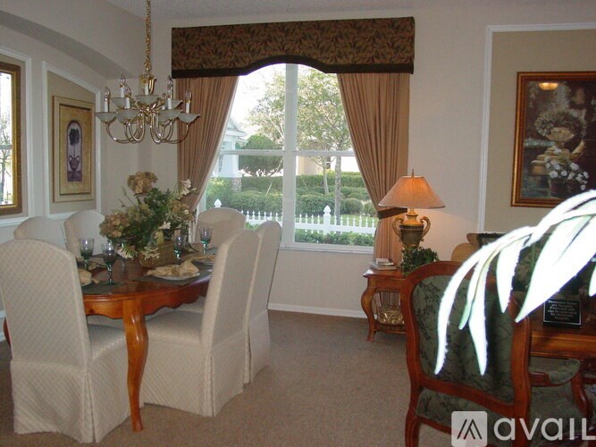 A dining room with a table set for a meal.