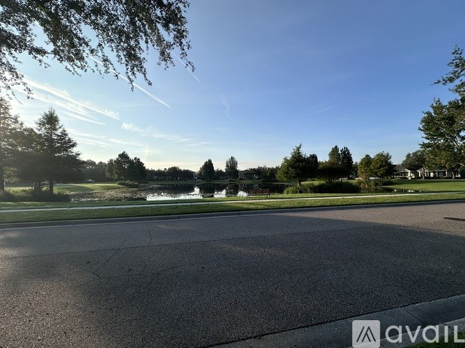 A road with a clear sky and trees in the distance.