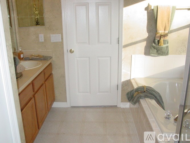 A bathroom with a white door and a white sink.