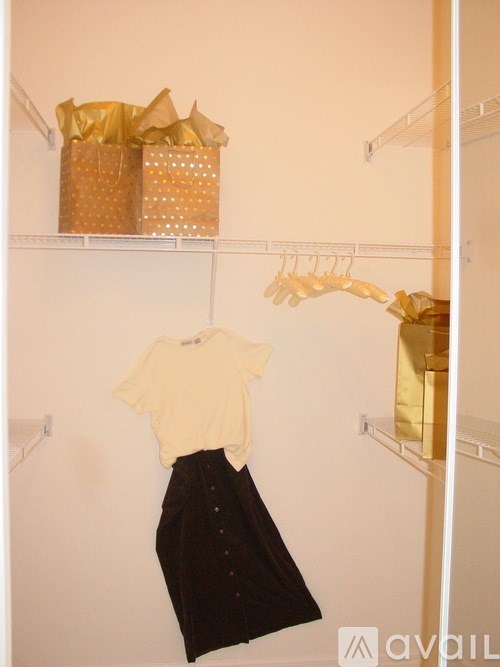A white shirt and black skirt hanging on a rack.