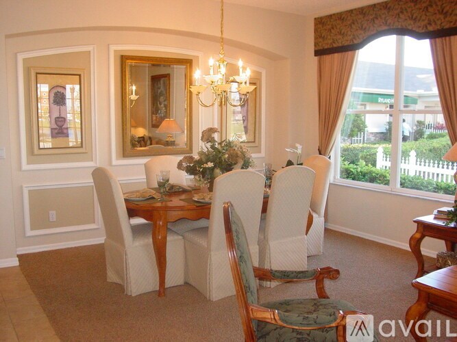 A dining room with a table set for six.