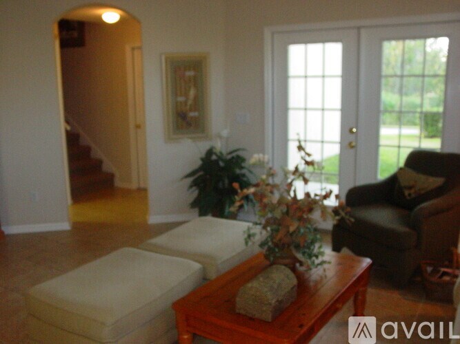 A living room with a couch, chair, and a coffee table.